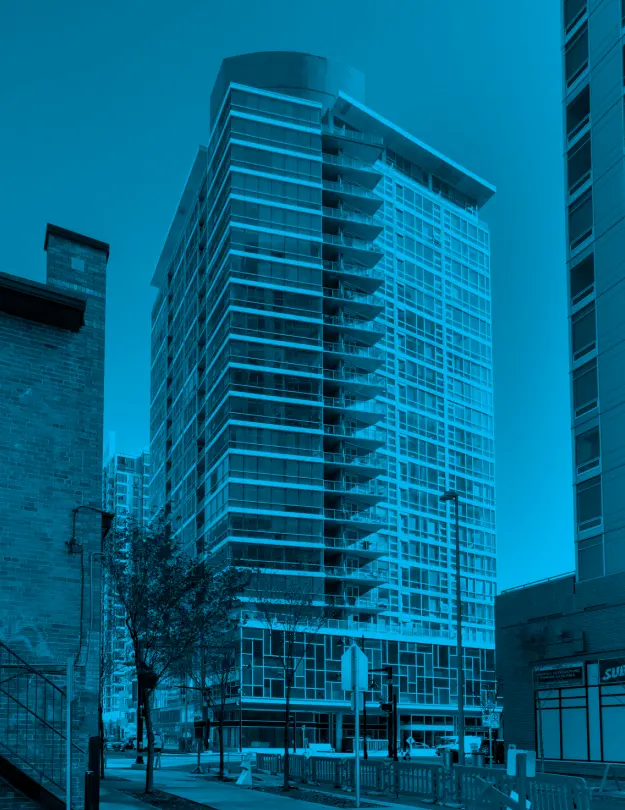 A tall glass-fronted residential tower representing the large-scale real estate assets held by a condo corporation.