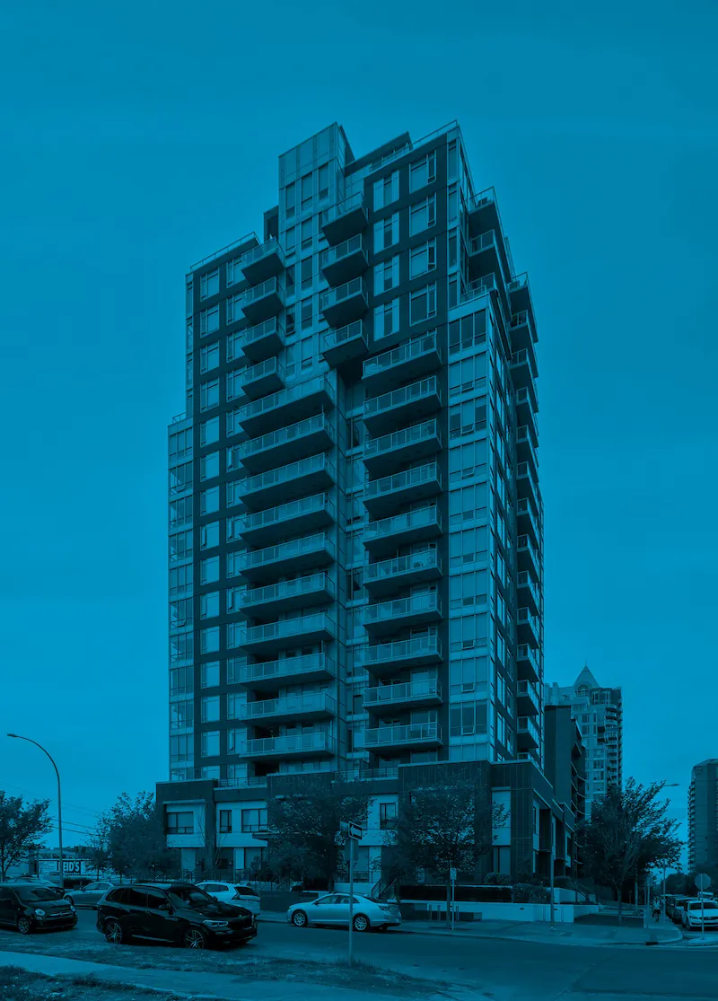 High-rise residential building with many balconies, illustrating a dense living space governed by condo noise rules and regulations.