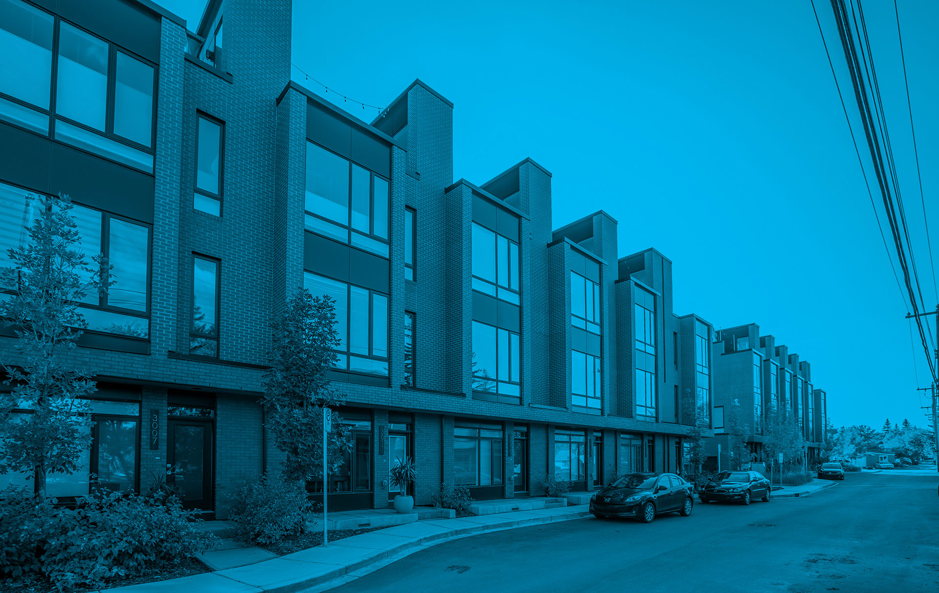 Modern townhouse condominium development illustrating condo project management, with multiple residential units requiring coordinated planning, construction oversight, and property management.