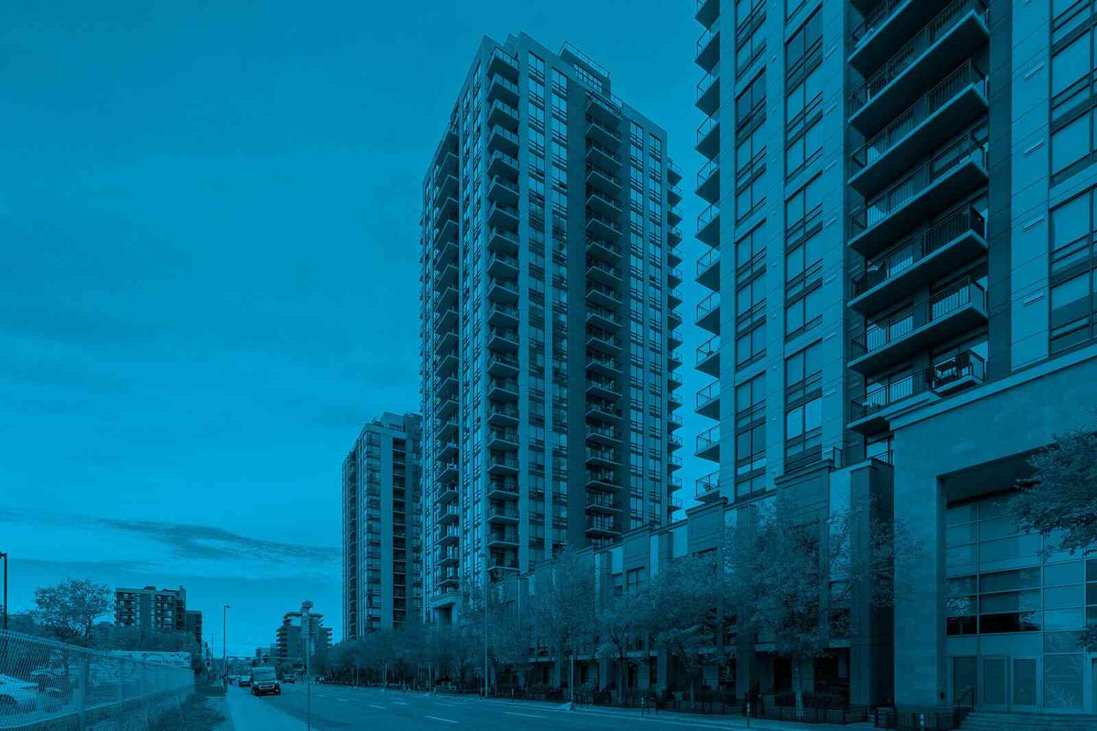 High-rise residential towers with modern glass architecture and balconies, showcasing what is luxury condominium living through high-value design and urban density.