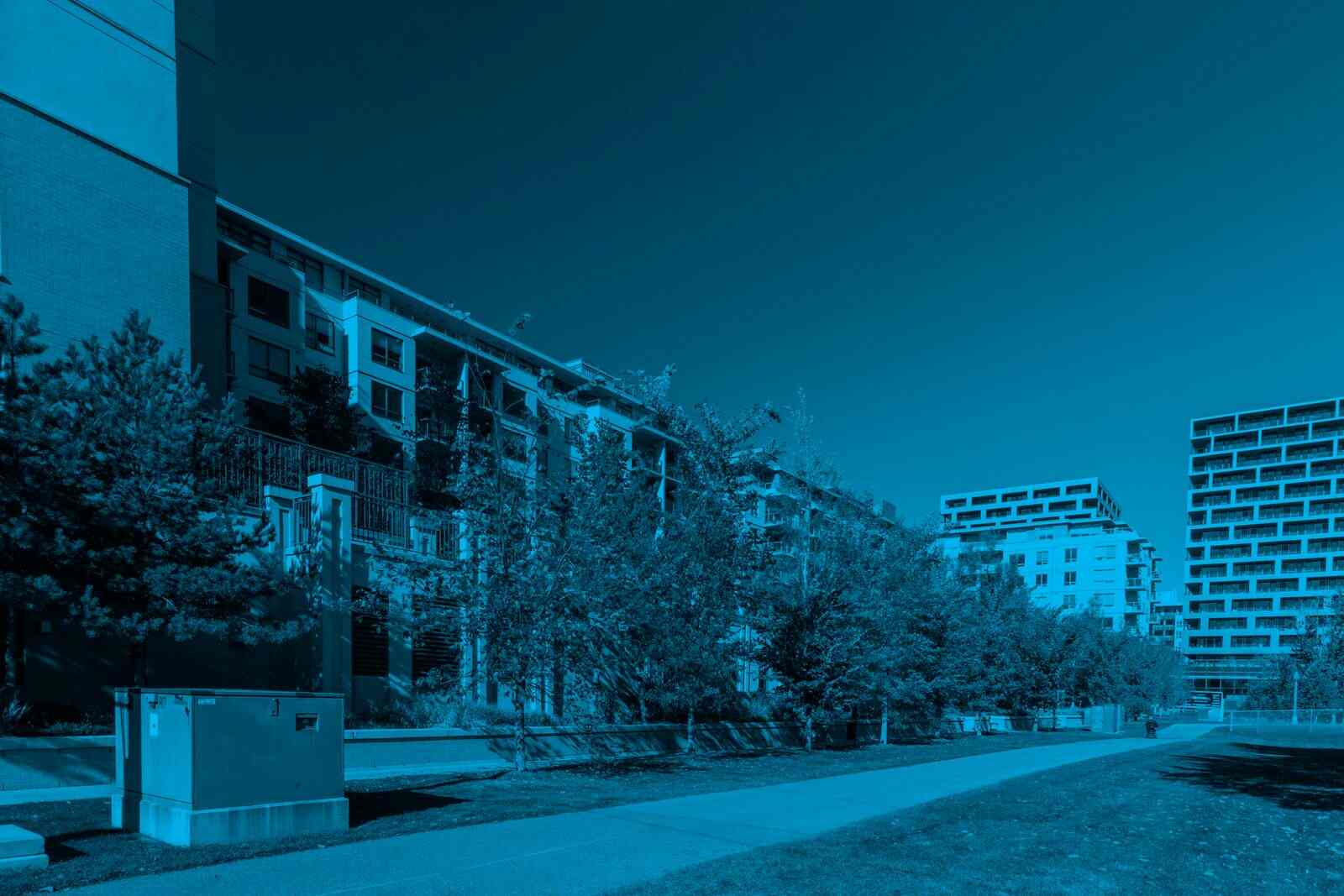 Modern residential properties representing a condo vs duplex ownership comparison.